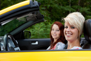 two girls in yellow car