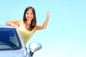 girl in car with thumbs up